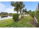 Landscaped backyard with lush greenery and a tranquil canal view at 13807 Karina St, Venice, FL 34293