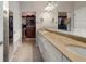 Large bathroom with double vanities, a walk-in closet, and a large mirror at 13807 Karina St, Venice, FL 34293