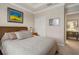 Spacious bedroom with window, neutral decor, and a dresser at 13807 Karina St, Venice, FL 34293