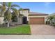Single-story home with attractive landscaping and a two-car garage at 13807 Karina St, Venice, FL 34293