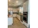 Modern kitchen featuring white cabinets, stainless steel appliances, and granite countertops at 13807 Karina St, Venice, FL 34293