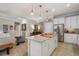 Modern kitchen with island, white cabinets and stainless steel appliances at 13807 Karina St, Venice, FL 34293