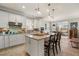 Modern kitchen featuring white cabinets, island, and stainless steel appliances at 13807 Karina St, Venice, FL 34293