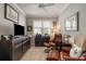 Relaxing office space with two leather armchairs and a media cabinet at 13807 Karina St, Venice, FL 34293