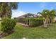 Screened pool surrounded by lush landscaping and a manicured lawn at 13807 Karina St, Venice, FL 34293