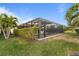Screened pool with lush landscaping and privacy hedge at 13807 Karina St, Venice, FL 34293