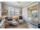 Bright sunroom with two comfy armchairs and sliding doors to the patio at 13807 Karina St, Venice, FL 34293