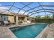 Relaxing rectangular pool with screened enclosure and patio furniture at 13807 Karina St, Venice, FL 34293