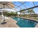Inviting swimming pool with screened enclosure and tranquil water views at 13807 Karina St, Venice, FL 34293