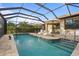 Refreshing swimming pool with a screened enclosure, ideal for relaxation at 13807 Karina St, Venice, FL 34293
