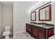 Bathroom with double vanity, granite countertops and large mirrors at 15554 Mccomb Cir, Port Charlotte, FL 33981