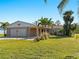 Tan house with white garage door and landscaping at 1771 Gale St, Englewood, FL 34223