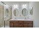 Double vanity bathroom with a walk-in shower at 20303 Lagente Cir, Venice, FL 34293