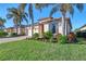 Single-story house with palm trees and well maintained landscaping at 20336 Pezzana Dr, Venice, FL 34292