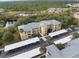 Aerial view of condo community showing building, parking, and landscaping at 2081 Willow Hammock Cir # F204, Punta Gorda, FL 33983