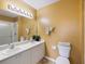 Double vanity bathroom with a shower and mustard-yellow walls at 2081 Willow Hammock Cir # F204, Punta Gorda, FL 33983