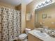 Clean bathroom with seashell-themed shower curtain and a single sink vanity at 2081 Willow Hammock Cir # F204, Punta Gorda, FL 33983