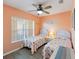 Guest bedroom with two twin beds, a ceiling fan, and beach-themed decor at 2081 Willow Hammock Cir # F204, Punta Gorda, FL 33983