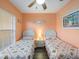 Guest bedroom with two twin beds, ceiling fan and beach decor at 2081 Willow Hammock Cir # F204, Punta Gorda, FL 33983