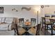 Bright dining area with glass table and four chairs, adjacent to kitchen at 2081 Willow Hammock Cir # F204, Punta Gorda, FL 33983