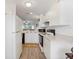 White kitchen with appliances, offering ample counter and cabinet space at 2081 Willow Hammock Cir # F204, Punta Gorda, FL 33983
