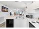 Modern kitchen featuring a breakfast bar, and a view to the living room at 2081 Willow Hammock Cir # F204, Punta Gorda, FL 33983