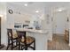 Kitchen with white cabinets, breakfast bar, and adjacent dining area at 2081 Willow Hammock Cir # F204, Punta Gorda, FL 33983