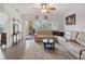 Spacious living room featuring a large sectional sofa and access to a balcony at 2081 Willow Hammock Cir # F204, Punta Gorda, FL 33983