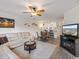 Open living room with sectional sofa and views into the kitchen and dining area at 2081 Willow Hammock Cir # F204, Punta Gorda, FL 33983