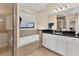 Bathroom with soaking tub, double vanity, and shower at 2090 Piave Ln, Venice, FL 34292