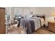 Bedroom with wood flooring and built-in desk area at 2090 Piave Ln, Venice, FL 34292