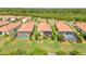 Aerial view of Sarasota National community, showing homes with pools and landscaped backyard at 24076 Spartina Dr, Venice, FL 34293