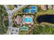 Community pool, tennis courts and clubhouse with pond at 287 Cassano Dr, Nokomis, FL 34275
