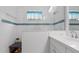 Bright bathroom with shower and blue tile accents at 287 Cassano Dr, Nokomis, FL 34275