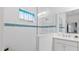 Bathroom with walk in shower and blue tile accents at 287 Cassano Dr, Nokomis, FL 34275