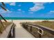 Boardwalk path to beach with ocean and people visible at 287 Cassano Dr, Nokomis, FL 34275