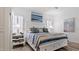 Main bedroom with a king-size bed and coastal decor at 287 Cassano Dr, Nokomis, FL 34275
