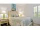 Guest bedroom with coastal decor and plantation shutters at 287 Cassano Dr, Nokomis, FL 34275