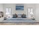 Spacious bedroom with a king-size bed, white nightstands, and blue bedding at 287 Cassano Dr, Nokomis, FL 34275