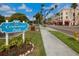 Centennial Park sign in front of shops and trees along a city street at 287 Cassano Dr, Nokomis, FL 34275