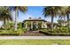 Community clubhouse with lush landscaping and palm trees at 287 Cassano Dr, Nokomis, FL 34275