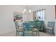 Dining area with teal chairs and glass table at 287 Cassano Dr, Nokomis, FL 34275