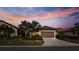House exterior view at dusk with palm trees at 287 Cassano Dr, Nokomis, FL 34275