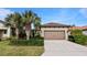 Single-story home with brown garage door and landscaping at 287 Cassano Dr, Nokomis, FL 34275