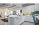 Open concept kitchen with white cabinets, stainless steel appliances, and a view to living room at 287 Cassano Dr, Nokomis, FL 34275