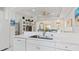 White kitchen features a large island with sink and breakfast bar at 287 Cassano Dr, Nokomis, FL 34275