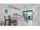 Bright white kitchen with stainless steel appliances and breakfast bar overlooking the pool at 287 Cassano Dr, Nokomis, FL 34275