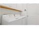 Laundry room with washer, dryer, and white cabinets at 287 Cassano Dr, Nokomis, FL 34275
