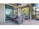 Covered patio with seating area, adjacent to kitchen at 287 Cassano Dr, Nokomis, FL 34275