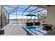 Screened pool area with patio furniture and lake view at 287 Cassano Dr, Nokomis, FL 34275